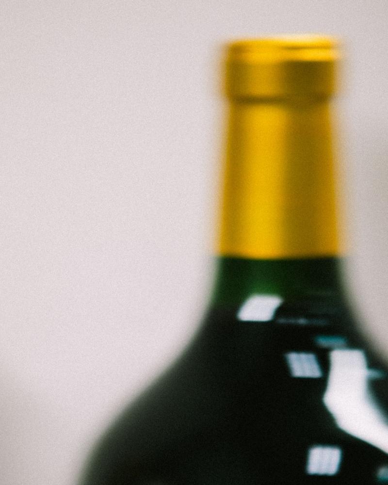 Macro of Pichon Comtesse wine bottle capsule with movement blur